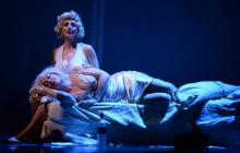 Two versions of Marilyn Monroe sitting on a bed