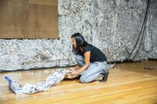 Woman kneeling on floor with tin foil