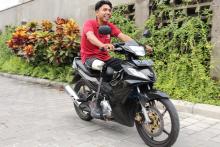 Man with prosthetic leg riding a motorbike.