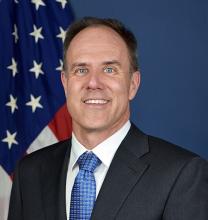 Portrait of Chris Gerdes in front of U.S. flag.