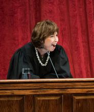 Female judge sitting behind podium. 
