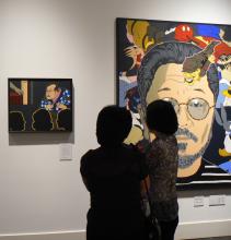 People looking at a museum exhibit. 