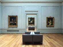 a blue-painted room at the National Gallery of Art in Washington, DC featuring several classic paintings