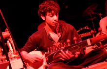 Man playing the stringed instrument, the sarod.