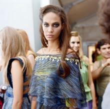 a model wearing a blue patterned gown