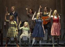 seven women onstage signing a scene from the play Spring Awakening