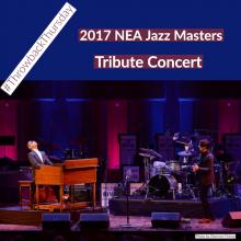 on stage a man plays a Hammond B-3 organ with a drummer and a guitarist