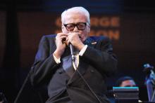 Toots Thielemans performs on the harmonica