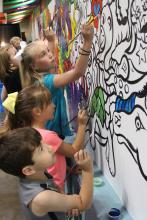 Children painting a mural