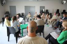 Group of prisoners reading scripts