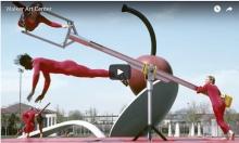 2 people performing a dance on an outdoor sculpture at the Walker Art Center