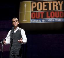 A young man stands behind a microphone mid-performance. A banner saying Poetry Out Loud is visible above his head
