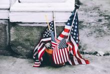 several small U.S. flags in a flower pot