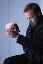 Man gazing at a skull