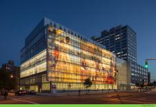 the facade of Harlem Hospital with an image projected on it