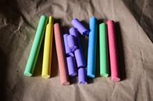 Four unique colored pieces of chalk.