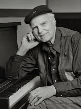 Portrait of Bob McQuillen sitting at the piano