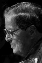 Hispanic man wearing glasses with short hair in profile.