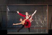 Two dancers in red costumes and masks