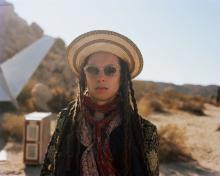 Photo of a man wearing sunglasses and a hat in the dessert