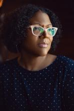 Author photo of Honorée Fanonne Jeffers, who is wearing pink glasses and a polka dot top.