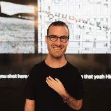 photography of Joshua Halstead who is a white man. He is wearing glasses and has close cropped hair
