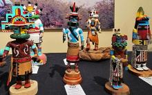 A display of colorful carved katsina dolls made by Hopi artists