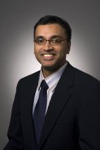 Sunil Iyengar, who is a South Asian man. He is smiling and wearing a dark suit and tie.