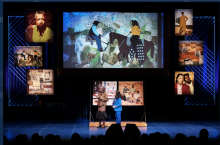 Marion Coleman at the 2018 Heritage concert against a background of her quilts