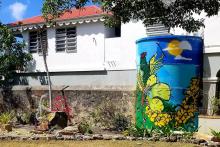 brightly colored water tower next to desert villa