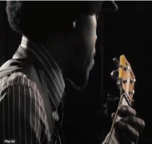 man playing ukelele.