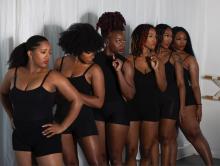 A group of Black women in black leotards.