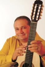 Man holding a cuatro.