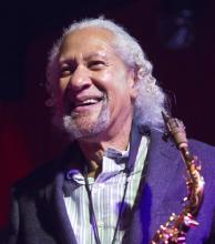 A man holding a saxophone.