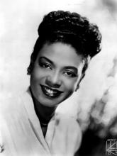 Black and white photo of a Black woman smiling