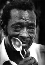 A man holding a large spoon.