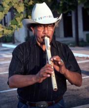 Man playing a flute.