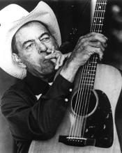 A man holding a guitar.