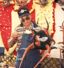 A man holding a mandmade mask.