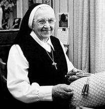 A woman posing with a handicartf lace.