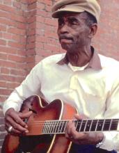 A man holding a guitar.