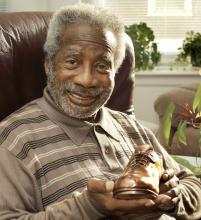 A man holding a shoe in his hand.