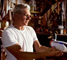 A man holding a model diuck in his hands.