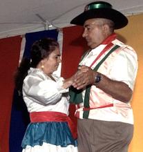 A man and a woman dancing toghether.