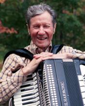 A man holding an accordion.
