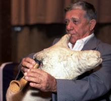 A man playing a skin bagpipe.