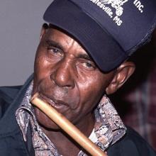 Man playing a flute.