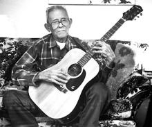A man playing the guitar.