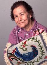 A woman showing a weaving.