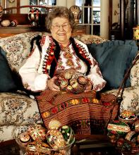 A woman sitting with her crafts.